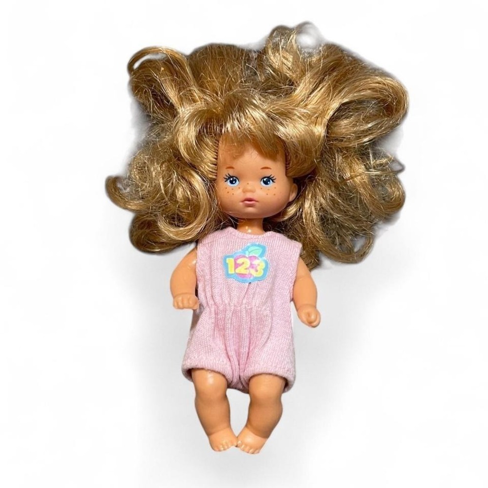 Vintage 1976 Mattel barbie doll with curly hair and pink romper
